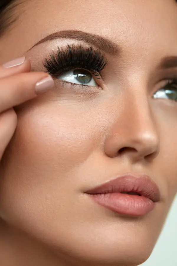Applying false lashes close-up